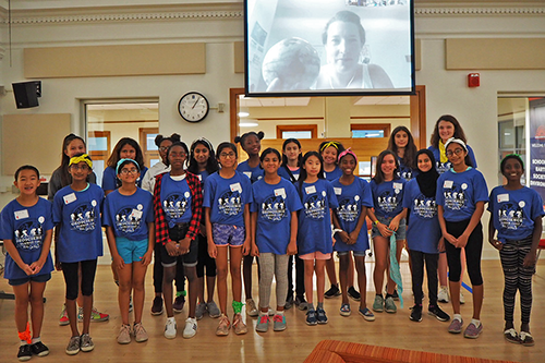 Middle school girls pose for a photo with a scientist (who joined them via Skype) at a geoscience camp for girls organized by doctoral students in the School of Earth, Society, and Environment. (Photo courtesy of Aida Guhlincozzi and Julia Cisneros.)