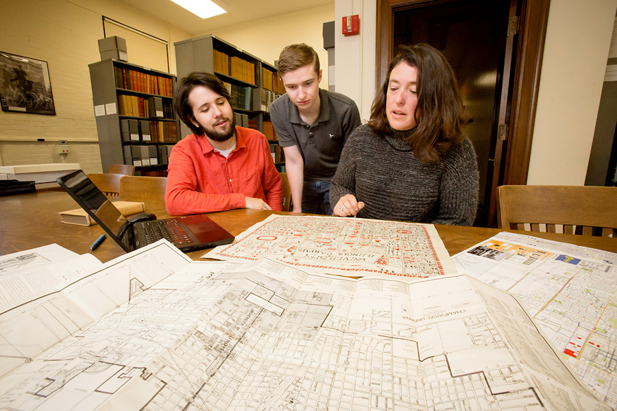 students and advisor studying map