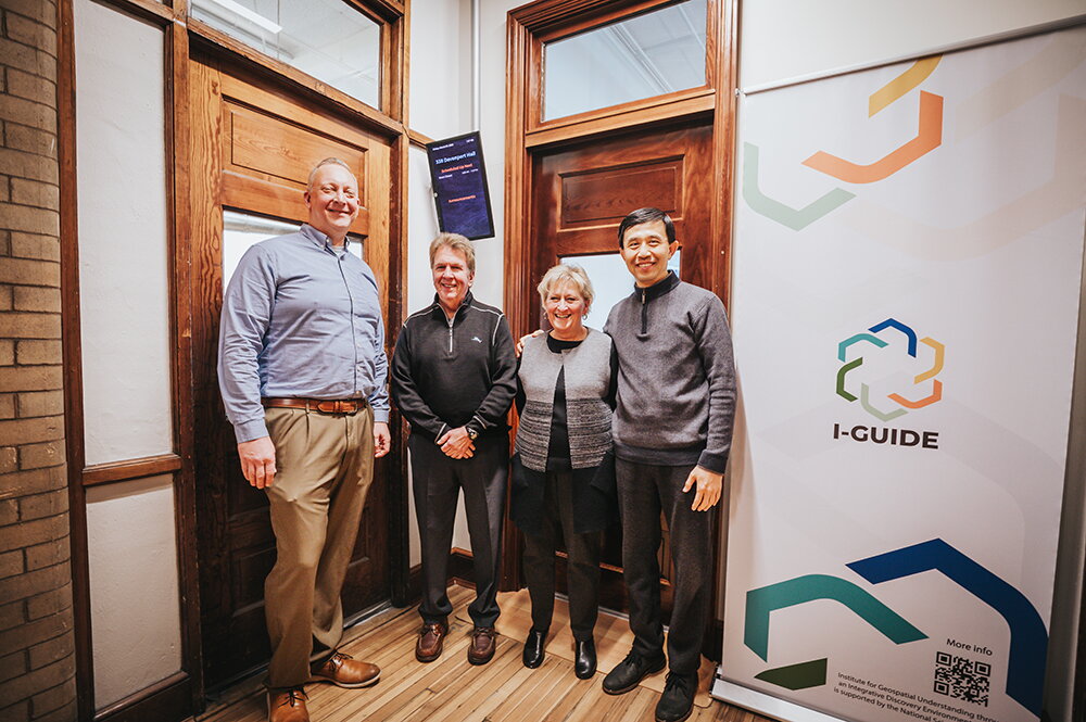 People posing for a picture in the I-GUIDE labratory.