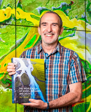 Jim Best with his book The World Atlas of Rivers, Estuaries, and Deltas.