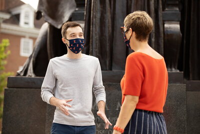students wearing masks at the alma mater